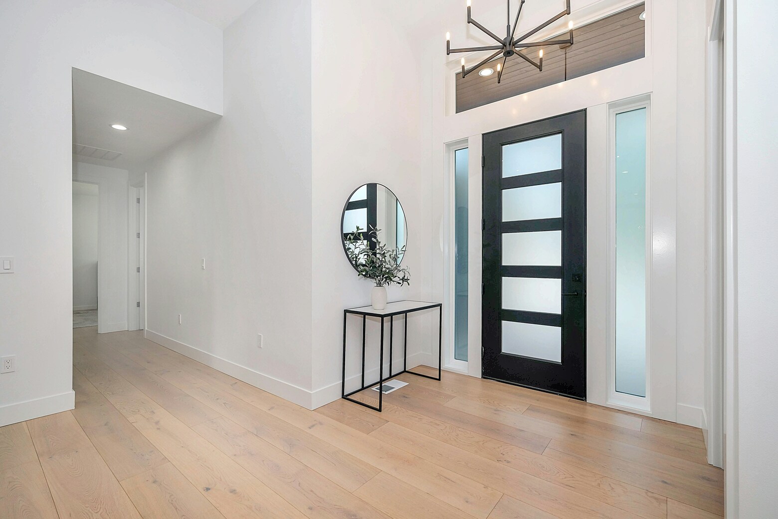 A modern looking entryway with white walls.